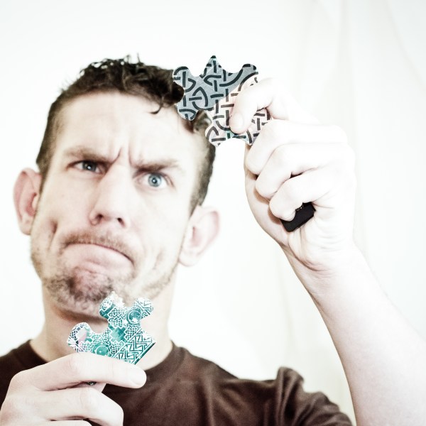 learning-german-confused-man-with-puzzle-pieces-fit-together